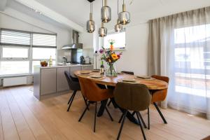 a kitchen and dining room with a wooden table and chairs at Watervilla Workum in Workum
