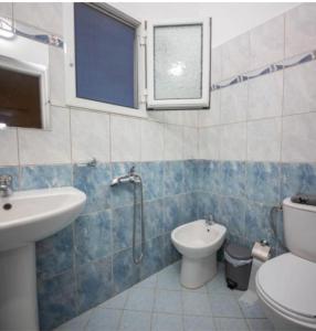 a bathroom with a toilet and a sink and a shower at Residence Vera in Ksamil