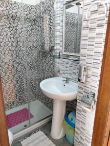 a bathroom with a sink and a shower at Hotel Lombardia in Seveso