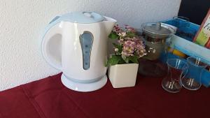 a white blender sitting on a table next to a plant at Apartmani Stolac in Stolac