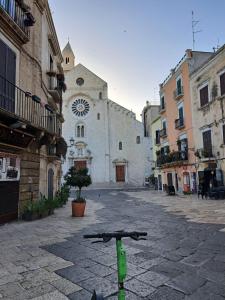 a bike parked on a street in front of a building at IL CORTILETTO in Bari