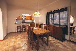 a kitchen with a wooden table and a dining room at Strand view apartment in Sliema