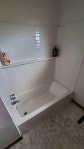 a white bath tub in a white bathroom at Pearl Cove in Santa Cruz