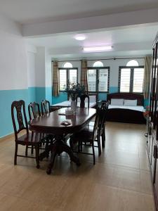 a dining room with a wooden table and chairs at HƯƠNG LAN HOTEL in Ho Chi Minh City