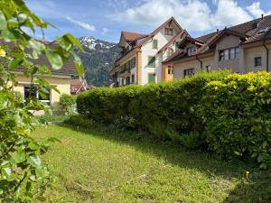 a hedge in a yard next to a building at Villa Epoka in Interlaken