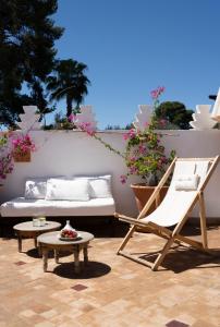 a patio with a couch and a chair and a table at Riad Sashema in Marrakesh