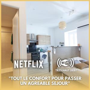 um quarto com uma cozinha com uma cama e um micro-ondas em Le Refuge Valencien - Douceur et Élégance em Valence-sur-Baïse