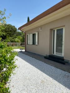 a house with a pathway leading to the front yard at La Campanula-exclusive pool in Santa Maria a Monte