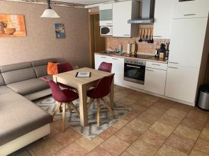a kitchen and living room with a table and a couch at Ferienwohnung Pölkentor in Quedlinburg