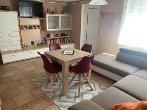 a living room with a table and chairs and a couch at Ferienwohnung Pölkentor in Quedlinburg +12 photos