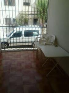 a room with a view of a white car in a parking lot at La casa de Paco y Lola in San José