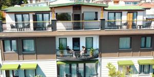 two people sitting on a balcony of a building at MAGİA HOTEL in Istanbul