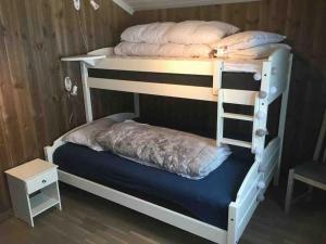 a bunk bed with a ladder on top of it at Hytte med god standard in Stranda
