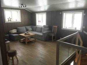 a living room with a couch and a table at Hytte med god standard in Stranda