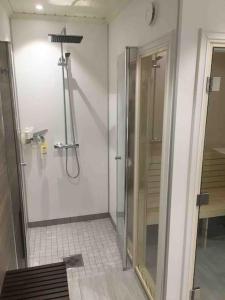 a bathroom with a shower with a glass door at Hytte med god standard in Stranda