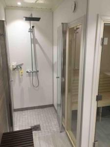 a bathroom with a shower with a glass door at Hytte med god standard in Stranda +15 photos