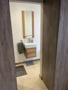 a bathroom with a sink and a mirror at Emara 27 in Potchefstroom +8 photos