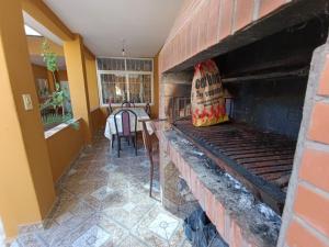 a brick fireplace in a room with a table at Arizona B&P in Termas de Río Hondo