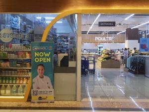 a view of a grocery store with a now open sign at The ICONIC: Comfortable living by Awsom Phil in Manila