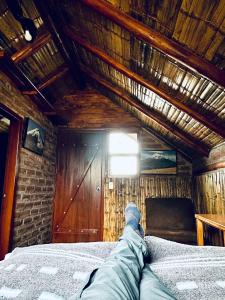a person laying on a bed in a room at Chimborazo Basecamp in Chimborazo