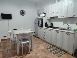 a kitchen with a table and a sink and a counter at Casa vacanza Flora in Grottazzolina +16 photos