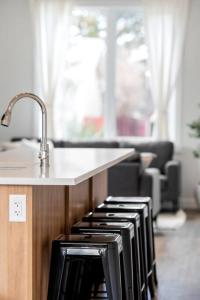 a kitchen with a stove with a counter top at Modern Luxury Home - King Bed•Arcade•WEM•A/C in Edmonton