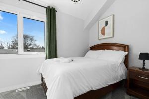 a bedroom with a bed and a large window at Modern Luxury Home - King Bed•Arcade•WEM•A/C in Edmonton