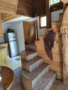 a set of stairs in a kitchen with a wooden wall at Relun Lodge in Villarrica
