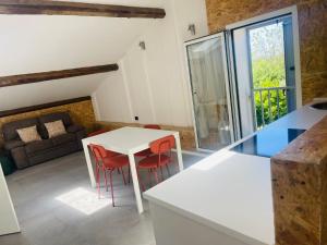 a kitchen and living room with a table and chairs at Affittacamere Nonna Ida in Carpi