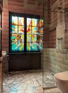 a bathroom with a stained glass window and a shower at Willa no.18 in Reda