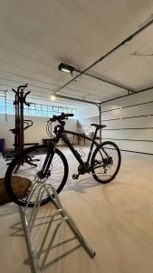 a bike parked on a stand in a garage at Garda View Apartment in Tenno