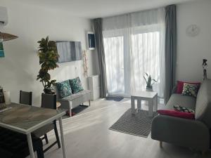a living room with a couch and a table at Marton Apartman in Balatonszemes