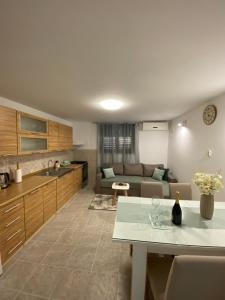 a kitchen and living room with a table and a couch at Apartment Bilic in Split