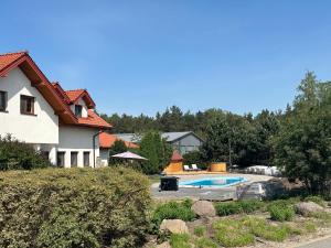a house with a swimming pool in a yard at Harmony Park in Kondrajec