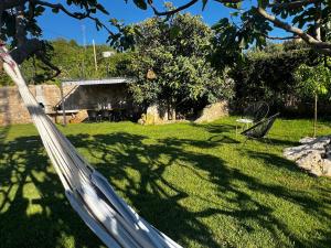 a hammock in the yard of a house at Meridiem Holiday Home in Dubrovnik region in Gruda