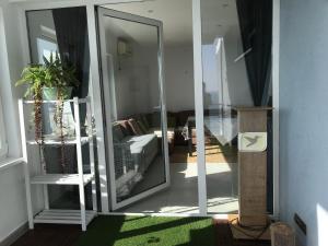 a living room with a sliding glass door at Apartament Costinești vedere epavă in Costinesti