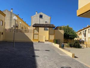 a cobblestone street in a town with buildings at Casa Rural Familiar , Castilleja del Campo , Sevilla in Seville