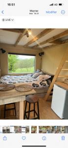 a room with a bed and a table and a table at La ferme de la truffe chambres d hôtes in Cuzance