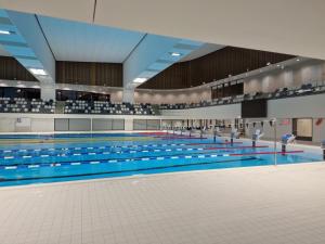 a large swimming pool with people in it at Home sweet Home in Vilnius