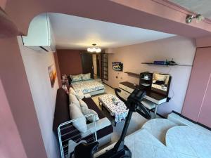 an overhead view of a room with a couch and a bed at Партерно Студио in Ahtopol