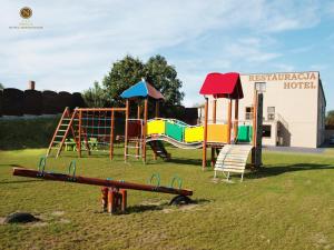 a playground with a slide and a play structure at Hotel Nekla in Nekla