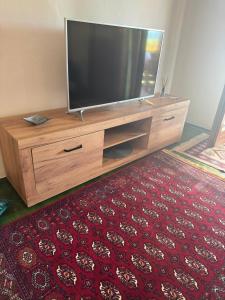 a flat screen tv sitting on top of a wooden entertainment center at Resting House Oaza in Bihać