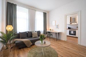 a living room with a couch and a table at BENVILLE Meißen - WLAN - Smart-TV - Free Parking in Meißen