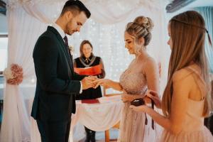 a bride and groom exchanging rings at a wedding ceremony at Harmony Park 