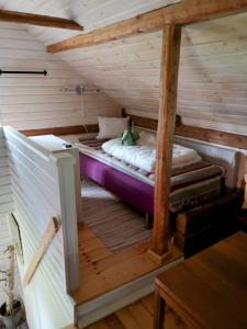 an attic room with a bed in the middle at Torpet Norra Lundåsen in Fristad