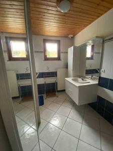 a bathroom with a sink and a mirror at La maison de Louise in Bians-les-Usiers +37 photos