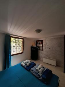 a bedroom with a bed with two pillows on it at Planinska kuća Bukulja in Arandelovac