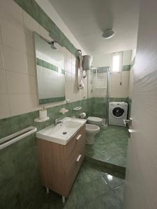 a bathroom with a sink and a toilet and a shower at Casa MaKiGiò in Vietri sul Mare