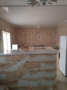 a kitchen with a large island in the middle at bienvenue agreable et chaleureuse in Biskra