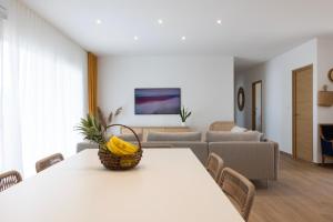 a living room with a table with a basket on it at Hôtel Les Lentisques in Cargèse